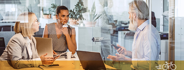 Business People Sitting at Desk, Discussing